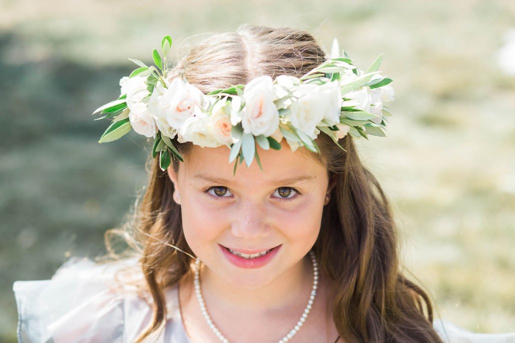 Flower girl wearing an ivory rose and olive leaf crown