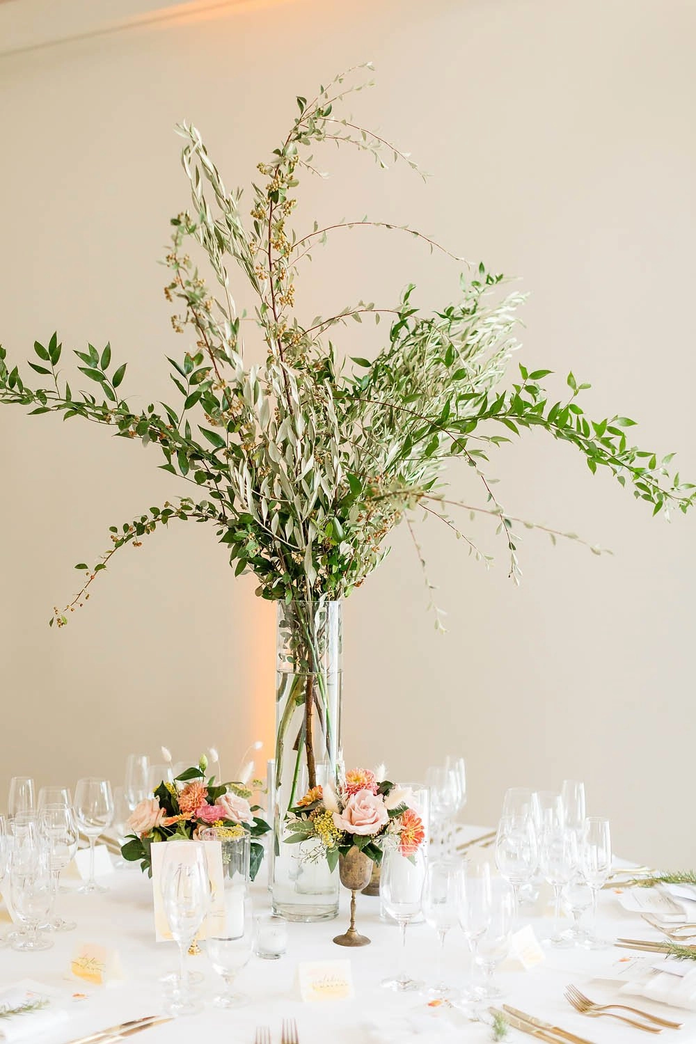 Tall greenery centerpiece on a reception table