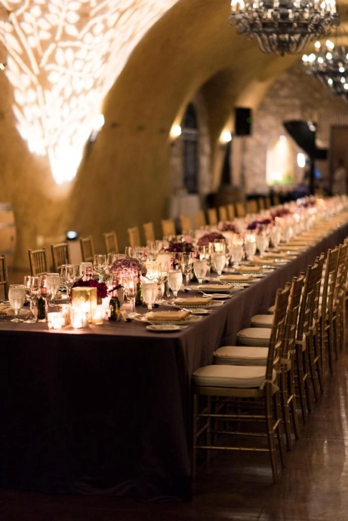 Cave dinner with blush centerpieces and chandeliers