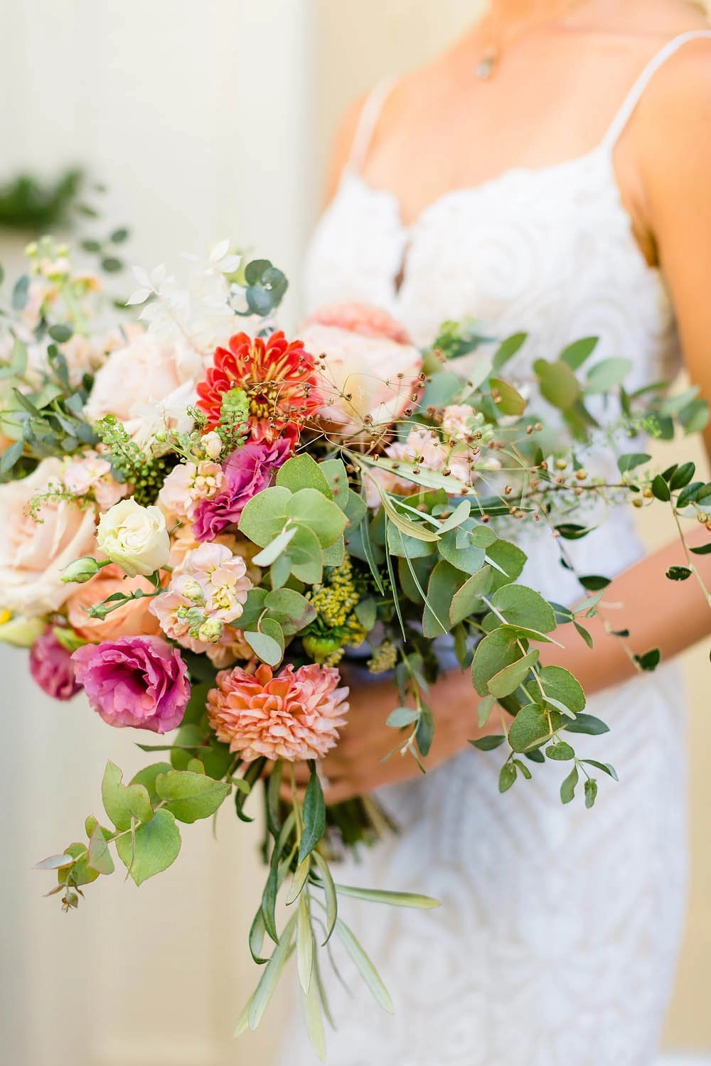 Bride holding a garden bouquet of roses, dahlias and eucalyptus