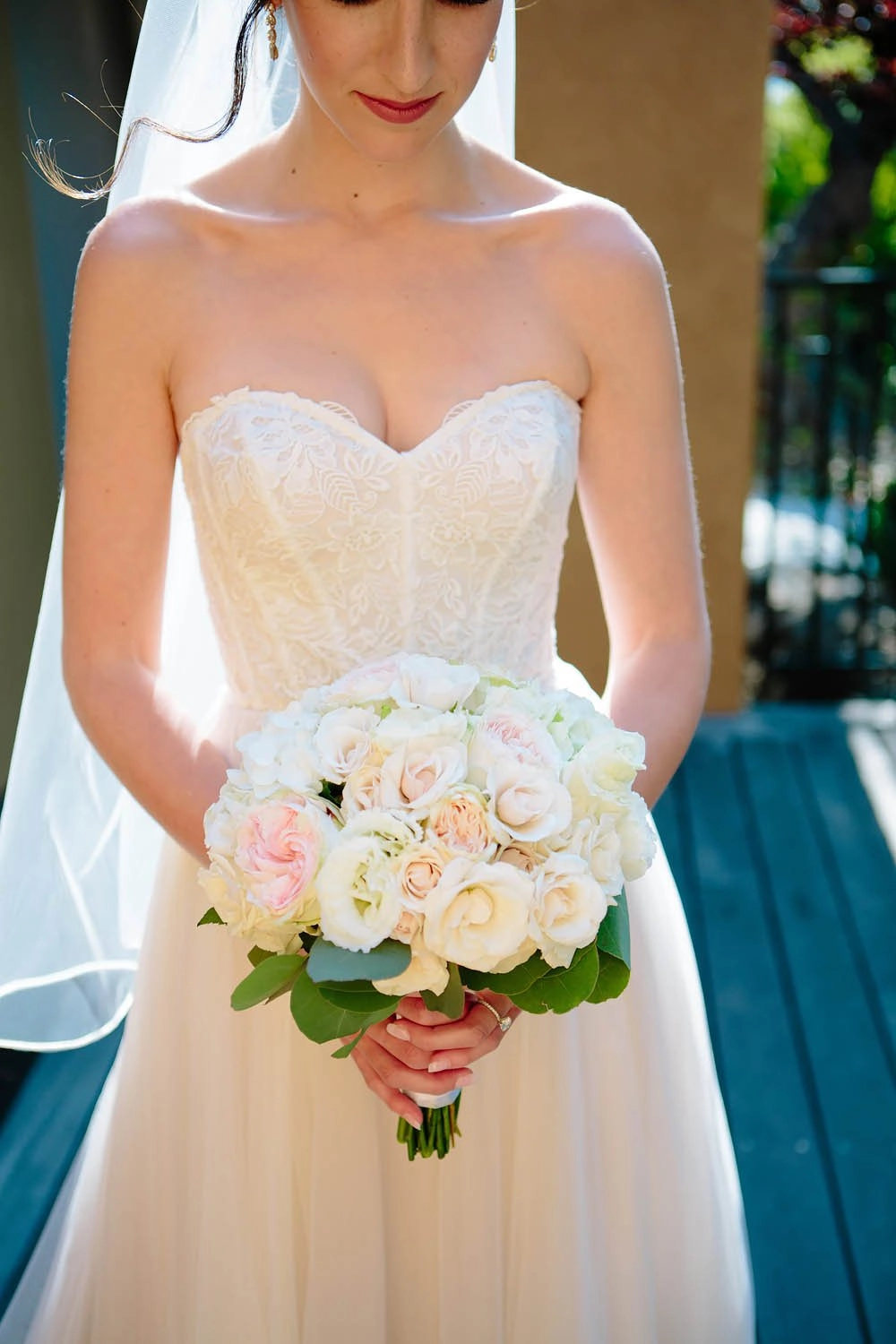 Bride holding a blush and ivory garden rose bouquet