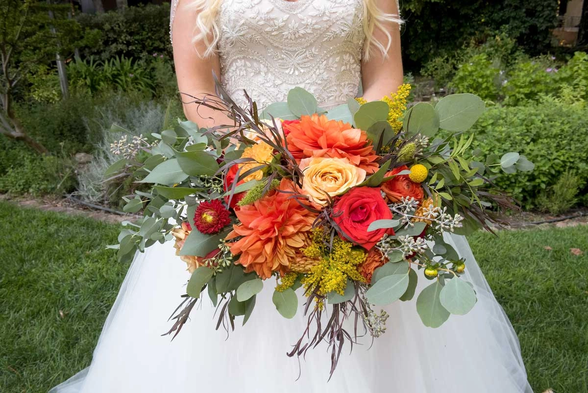 Autumn bridal bouquet of orange dahlias and roses
